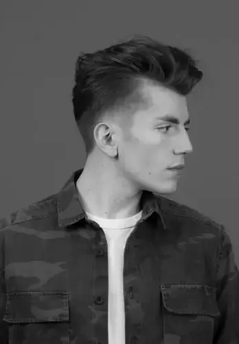Man with low fade and quiff looking to the right