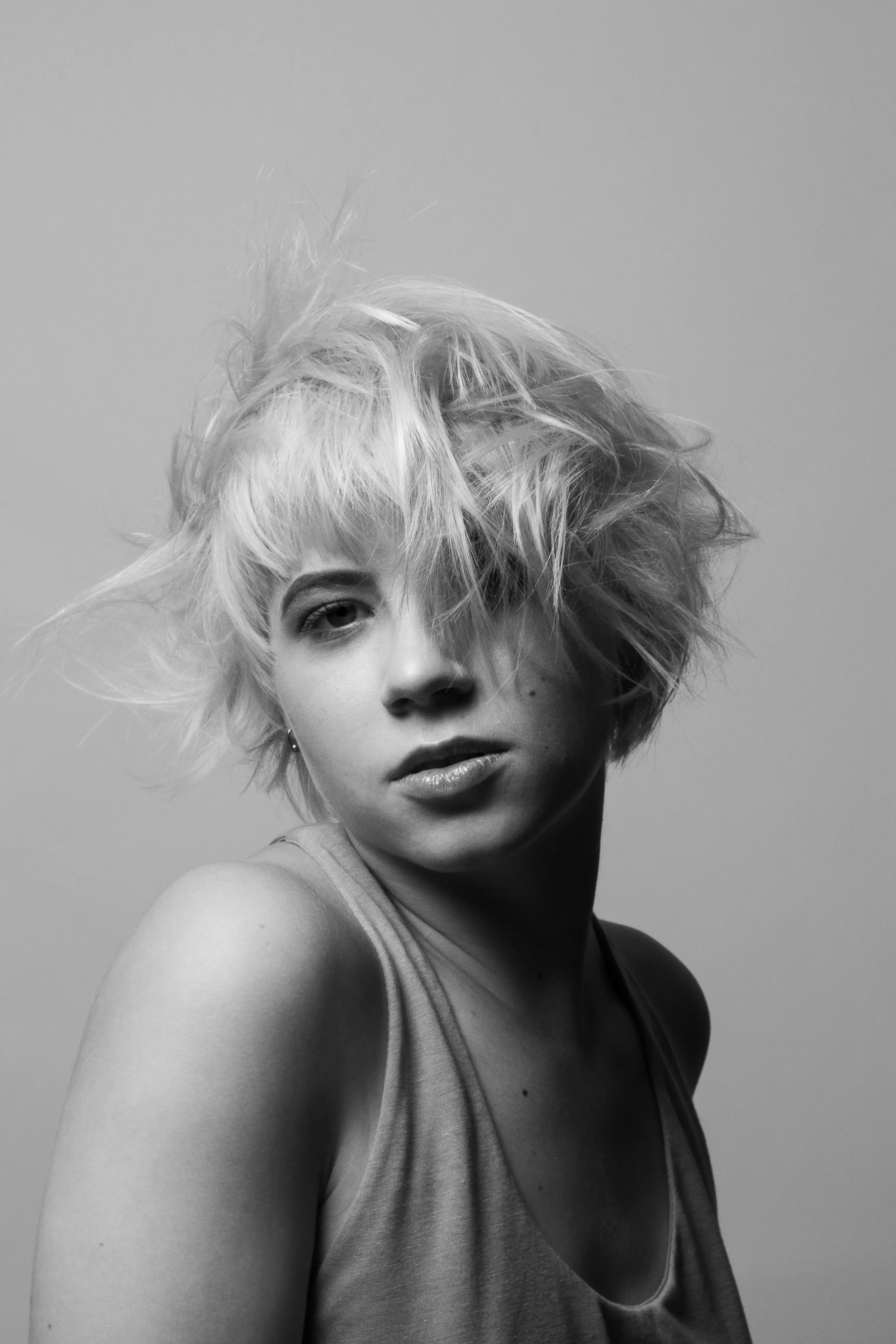 Woman with blonde messy hair in black and white