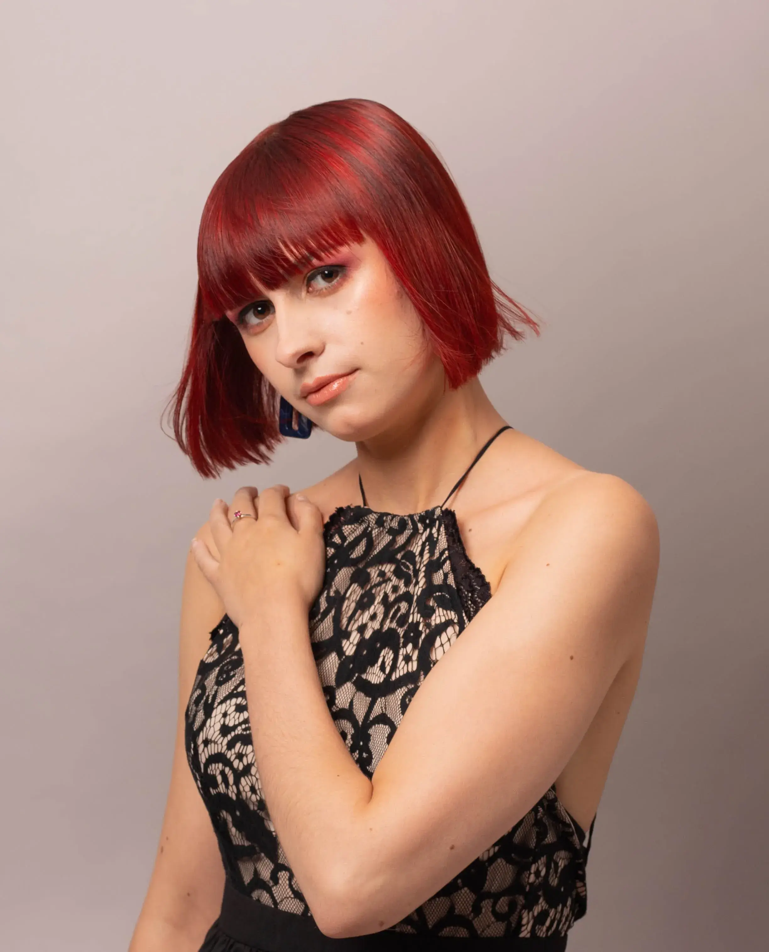 Woman with red bob cut with a full fringe
