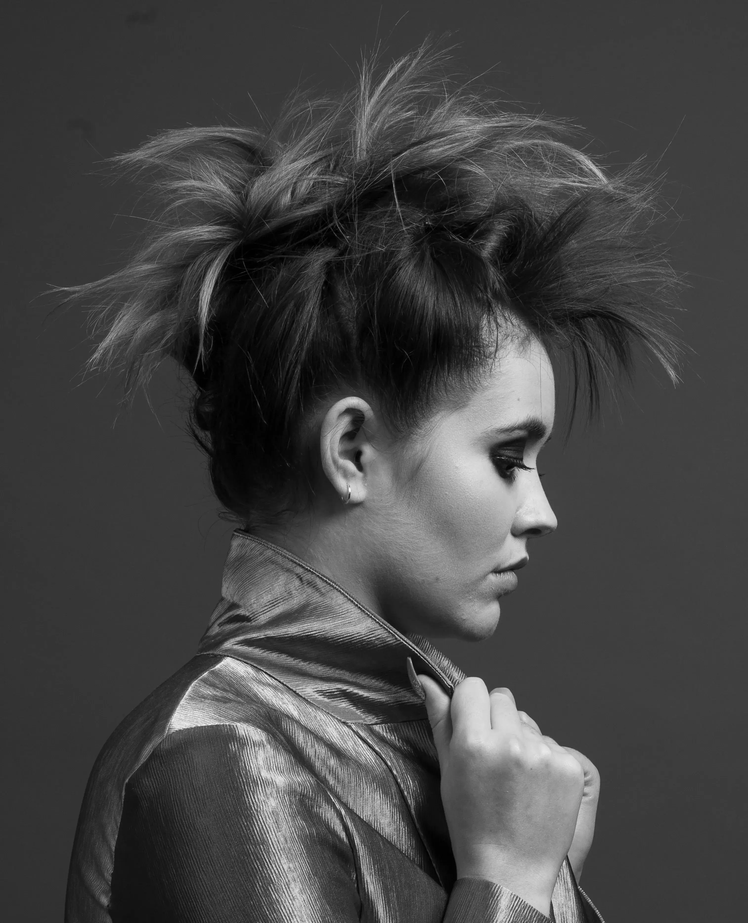 Woman with updo in mohawk style looking right