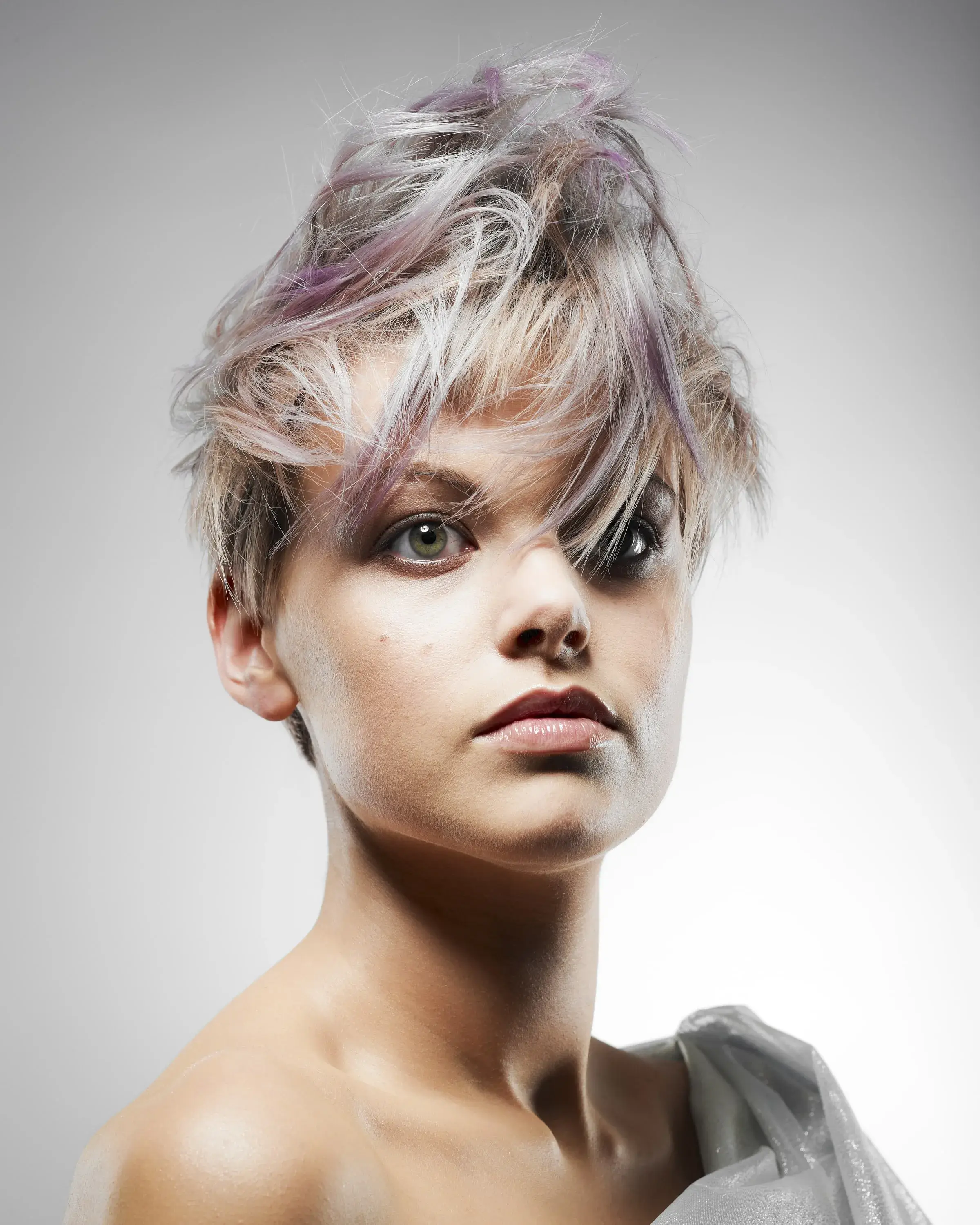 Woman with lilac and blonde hair in a pixie cut