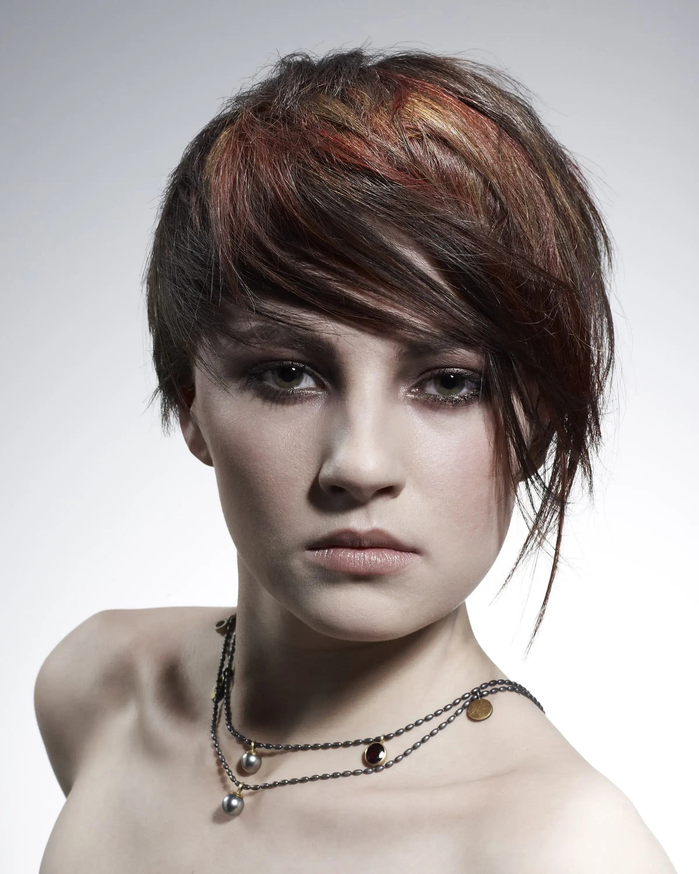 Woman with short brown hair with dramatic fringe
